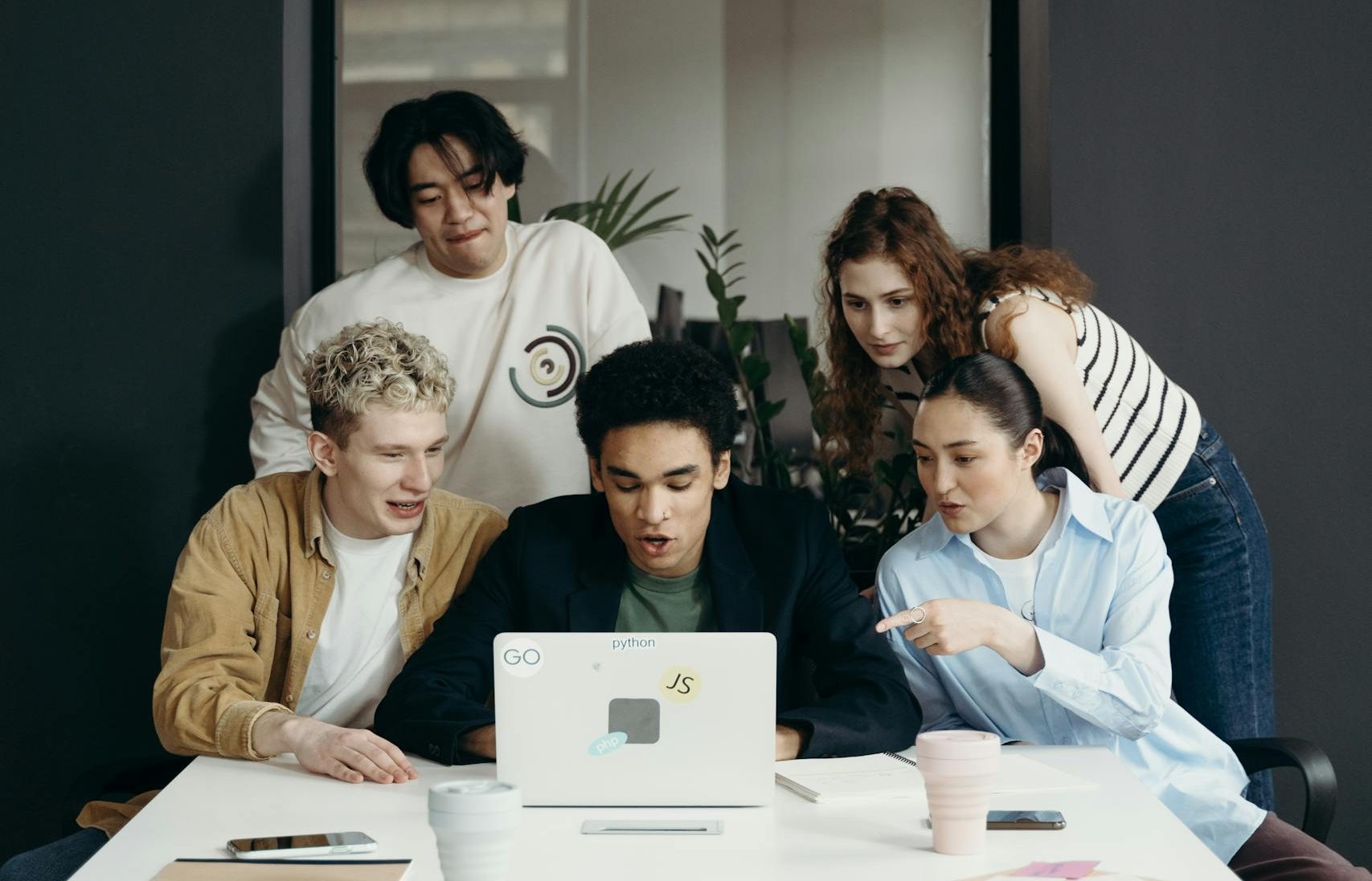 Abstract depiction of human-technology interaction with diverse hands and data flow.